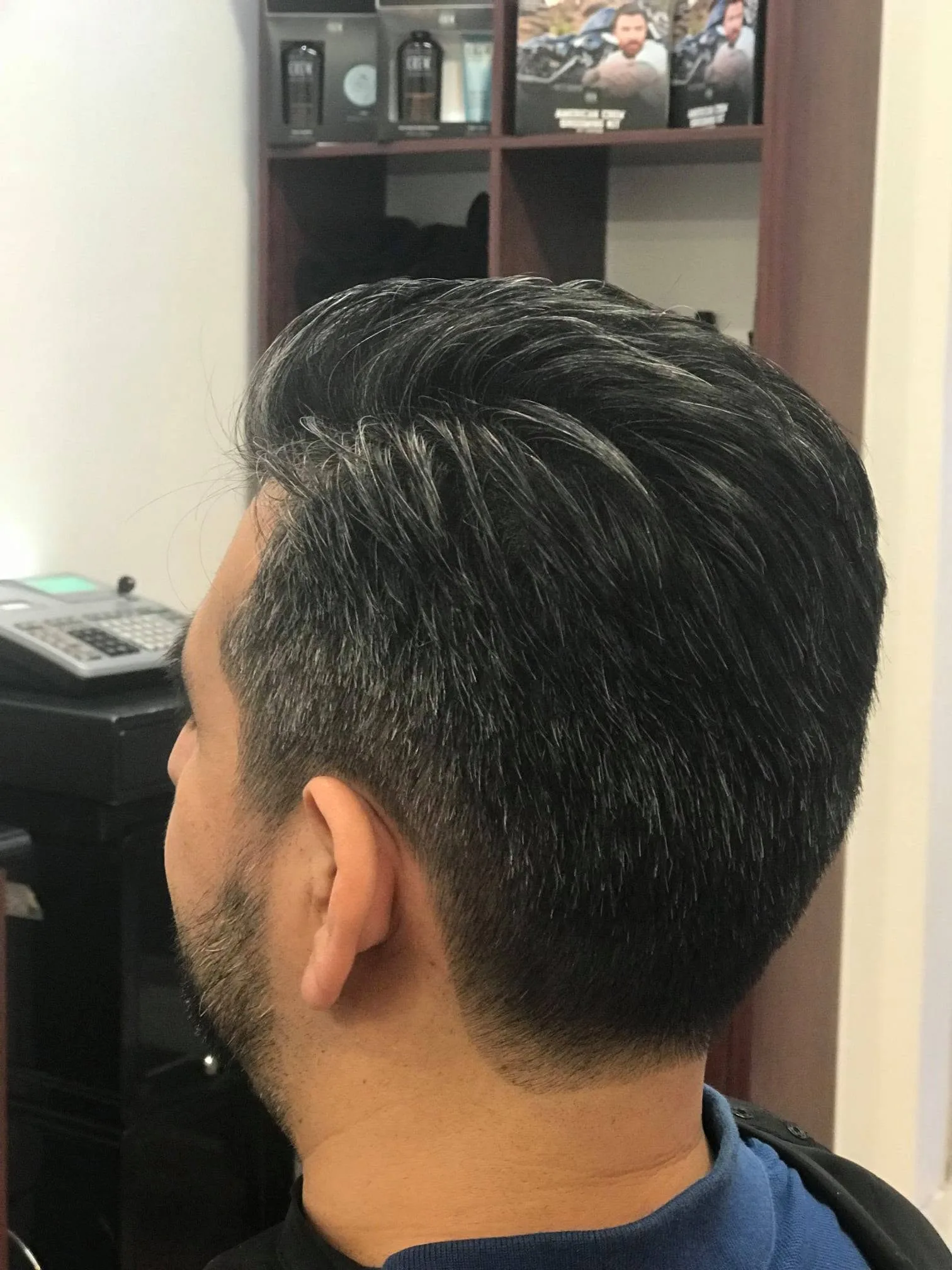 Finished textured cut with American Crew products behind
